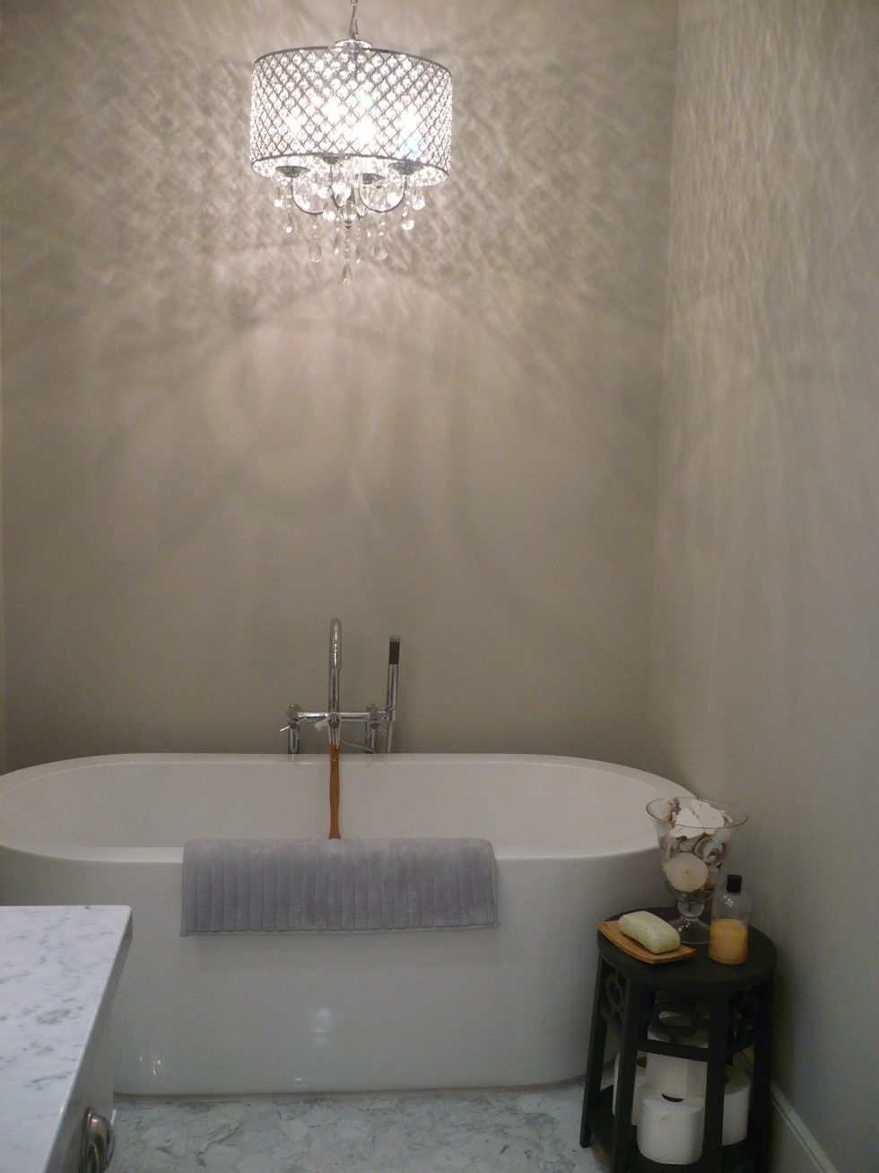 Remodeled Sacramento bathroom with new bathtub, lighting, and tile floor