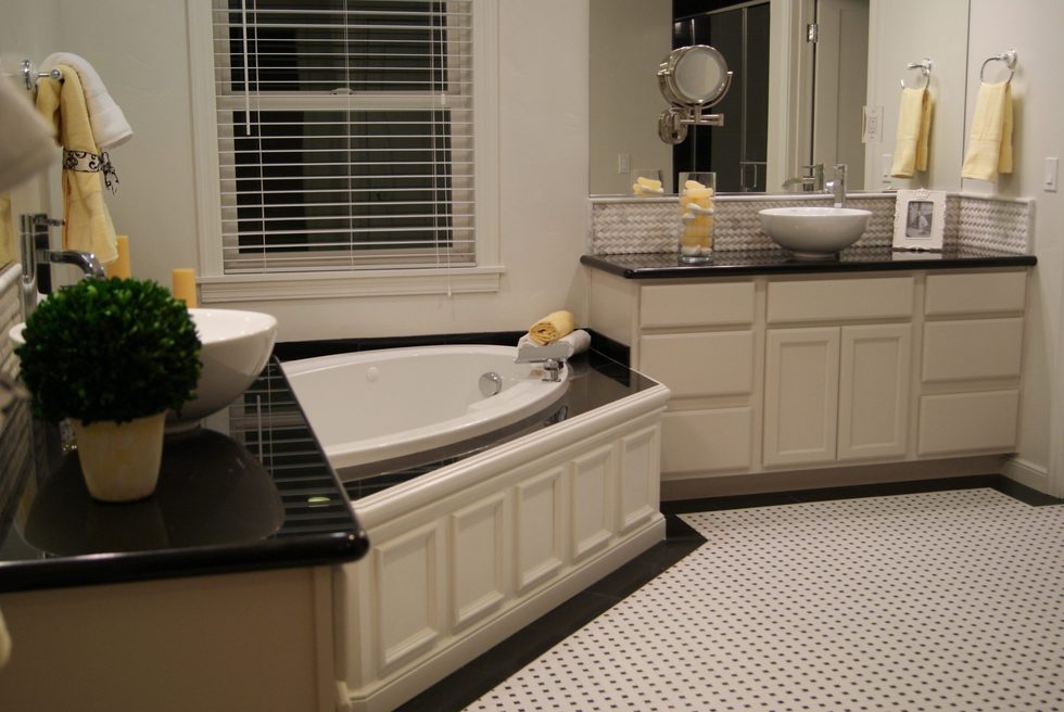 Sacramento bathroom renovation with bathtub, cabinets, sink, and tile