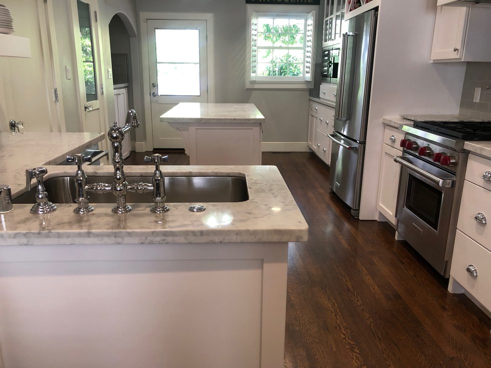 Sacramento kitchen renovation with marble counters, custom cabinets, and wood flooring